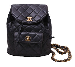 Vintage 1990's Chanel dark brown leather backpack with gold chain straps and gold hardware.