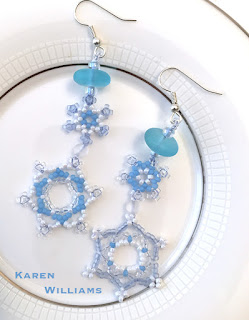 each earring features two linked snowflakes, topped with a cultured sea glass bead.