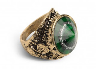 chunky gold and green ring with swirls and beading around the setting