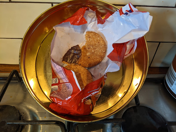 The last two chocolate hobnobs in the tin, one bitten