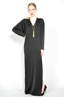 Vintage 1970's black maxi dress with gold details across the back and side slit opening.
