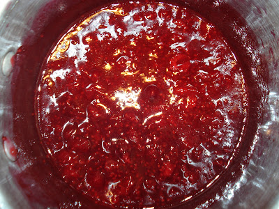 Raspberries simmering in a pan