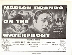 A black and white poster for "On the Waterfront," prominently featuring a photograph of Marlon Brando with other actors in the background.