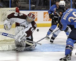 Jose Theodore of the Colorado Avalanche makes a save in a game against the Atlanta Thrashers