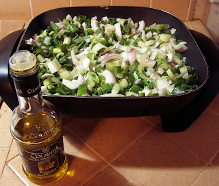 Frying Pan with Onions and Garlic, and Olive Oil Bottle