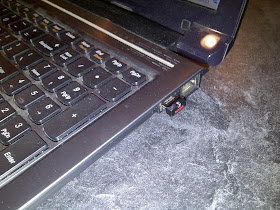 Shows flash drive installed in USB port of laptop computer