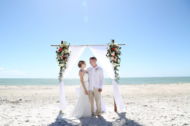 sanibel island wedding photographs with floral arch