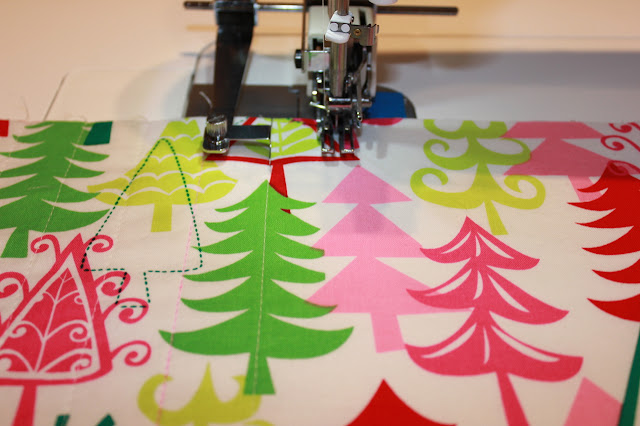 piece of holiday fabric with straight line quilting on machine