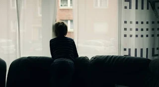 looking through the window because of loneliness