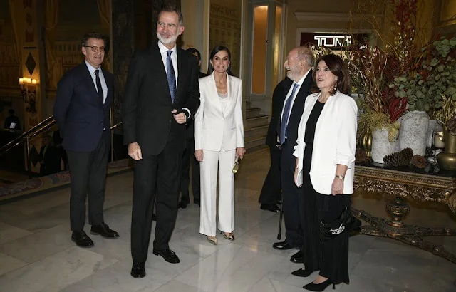 Carolina Herrera trousers. Queen Letizia wore a white blazer by Carolina Herrera, and a lace trim blouse by Zara