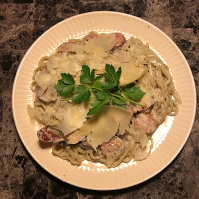 Basil and garlic linguine tossed in Boursin cream sauce with smoked sausage and shallots