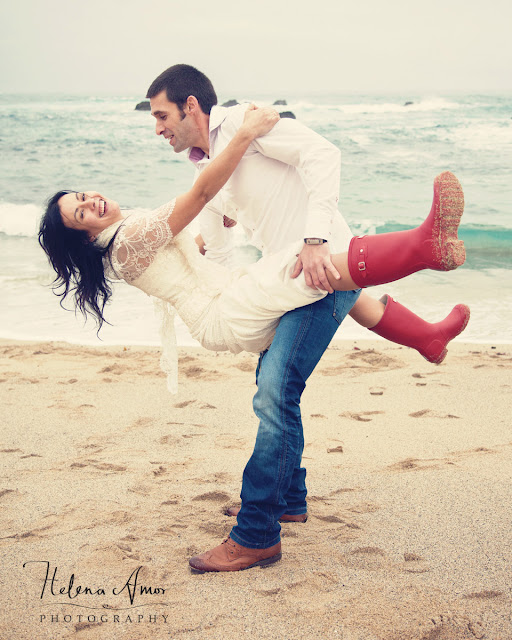 Playful bride and groom at the beach