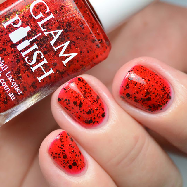 red nail polish with black glitter swatch