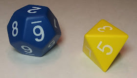 A large blue d12 and a large yellow d8, both made of the same foam used to make stress squeeze toys.