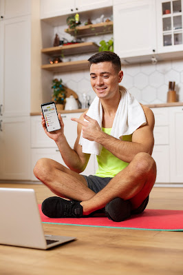 A-man-holding-device-to-adjust-time-with-the-virtual-personal-trainer