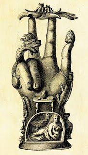 Possible magic item: Ornate statuette in the shape of a hand decorated with reliefs