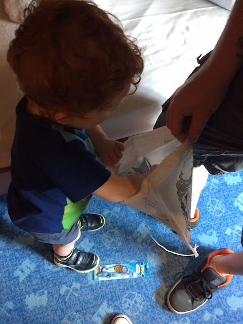 Little boy looking in a goody bag