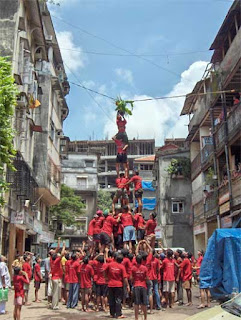 Govindas forming a human pyramid  to reach the Dahi Handi, Wikipedia