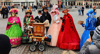 Amazing costumes next to the organ grinder