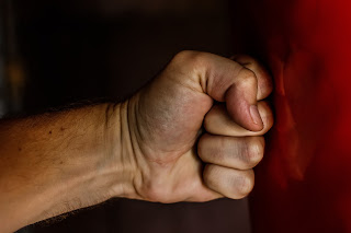 photo of a fist hitting a wall.