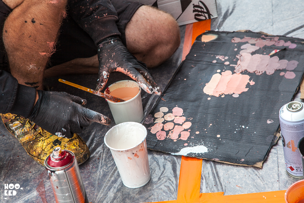 South African street artist Sonny mixing paint for his Electric Fury mural in Waterford Ireland.