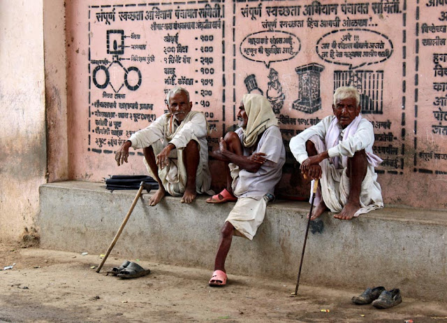 group of three old men sitting