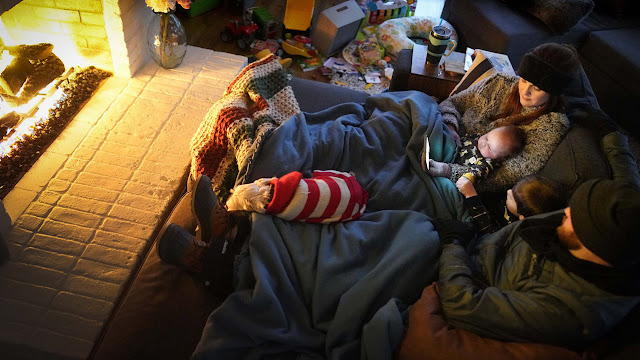 The Bryant family of Garland, TX huddled in front of the fireplace with their kids and their dog.