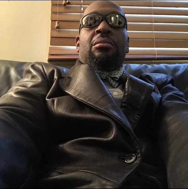 BusPimp Leather Suit Wearing Handsome Bearded Black Daddy Sporting Shades, Gloves and Sexy Attitude