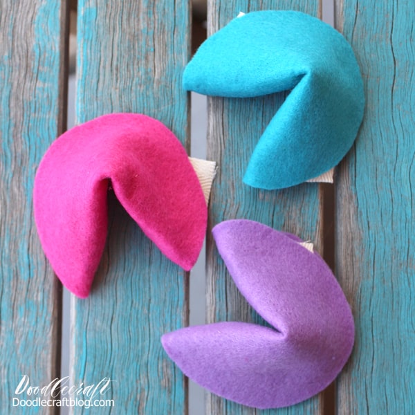 How to Make Felt Fortune Cookies!  I love fortune cookies! I love picking a fortune cookie and hoping for an actual fortune, but alas, a witty quip or odd saying. Make your own cookies and include actual fortunes!    These colorful felt fortune cookies are easy to make and take less than 15 minutes.  They are perfect reusable play food toys.     Make a bunch of brightly colored fortune cookies for imaginative play, as a decoration, or string them up on a garland!