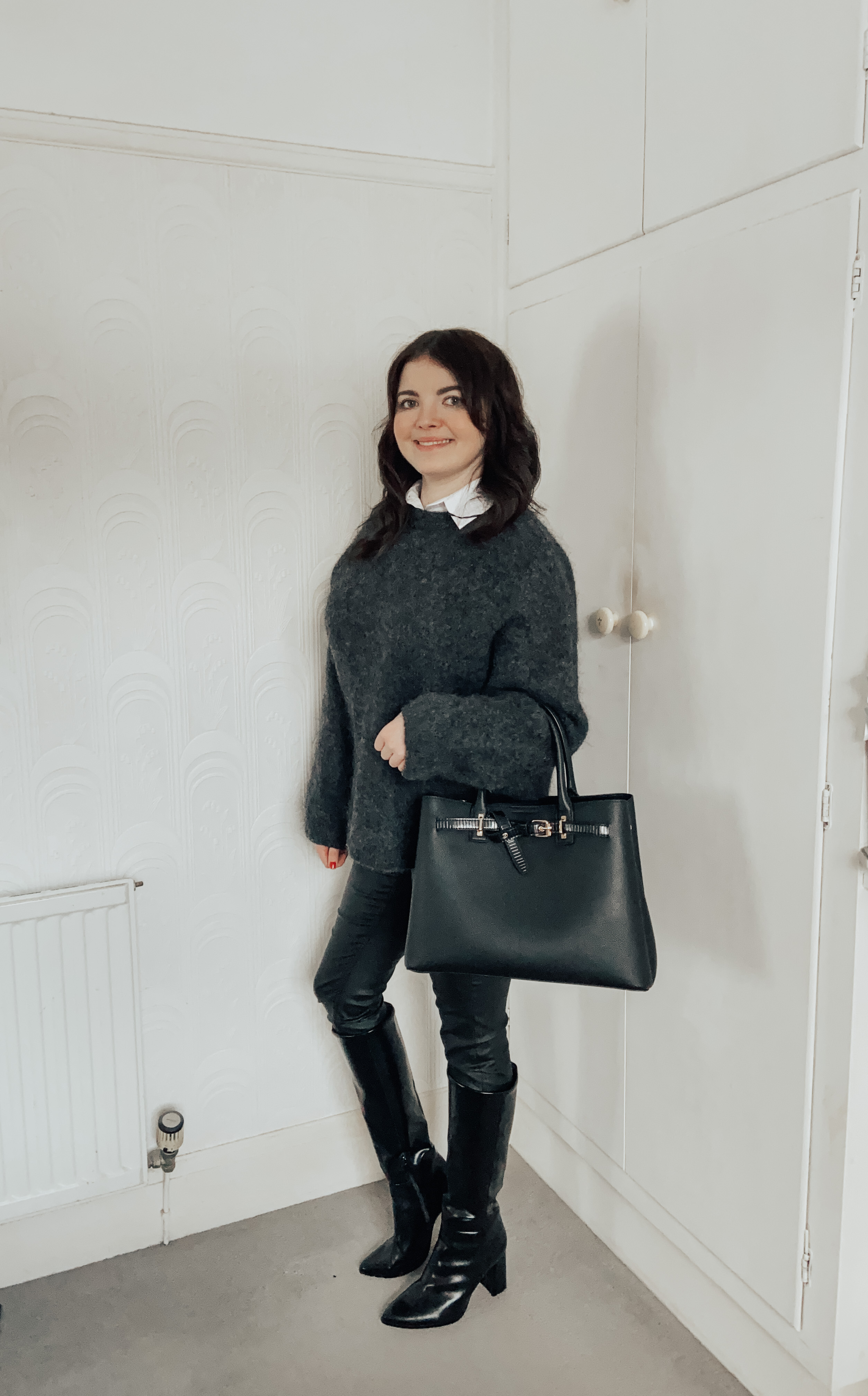 A woman wearing a dark grey H&M jumper.