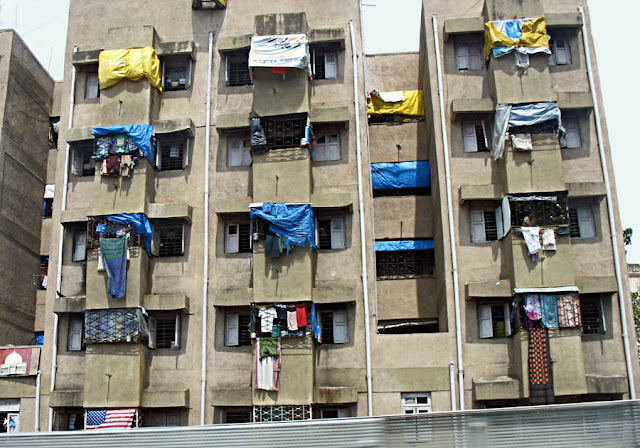 clothes hanging out to dry on tiny balconies