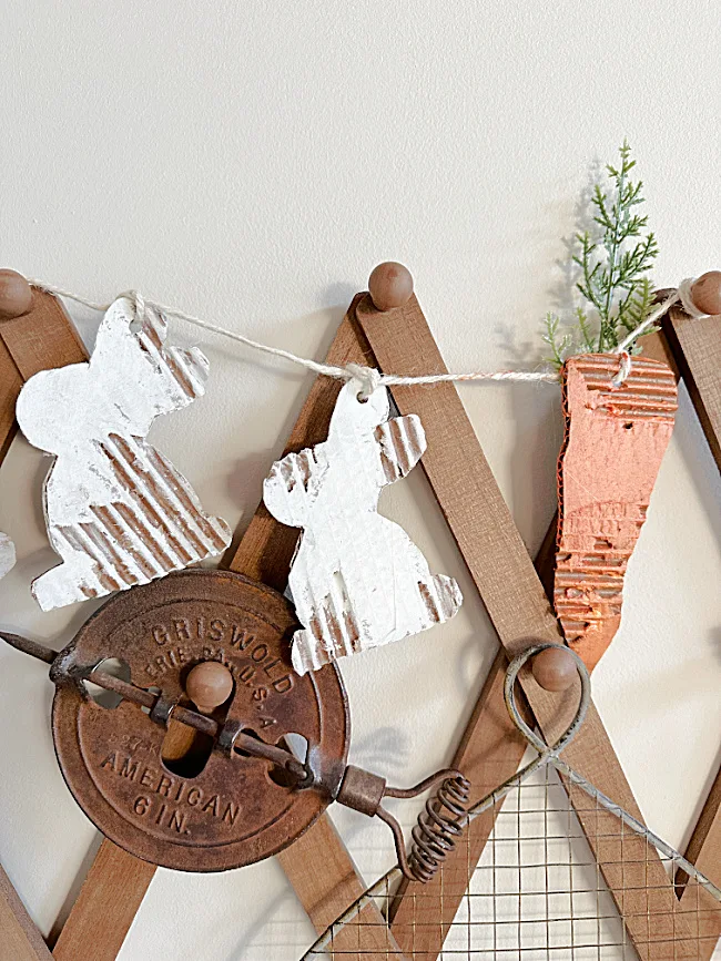 cardboard bunny banner on peg shelf with rusty things