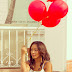 Woman Holding a Red Balloons