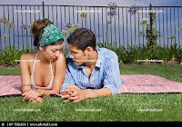 couple relaxing on blanked