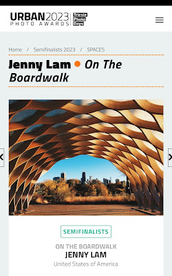 A screenshot of Jenny Lam's "On the Boardwalk" photograph as one of the Semifinalists of Urban Photo Awards 2023, Trieste Photo Days. The photo was shot on an iPhone 5s in 2014 and is of the pavilion by Studio Gang in the Lincoln Park Zoo's Nature Boardwalk in Chicago. The photo is composed in such a way that the sculptural pavilion frames Chicago's skyline.