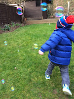 Little boy playing with bubbles