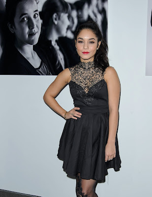 Vanessa Hudgens wearing fit-and-flare dress with a matching blazer, booties, and tights which had a sexy vine pattern scaling her legs