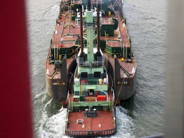 Under the Bridge - A tug pushes an oil barge under the Williamsburg Bridge.