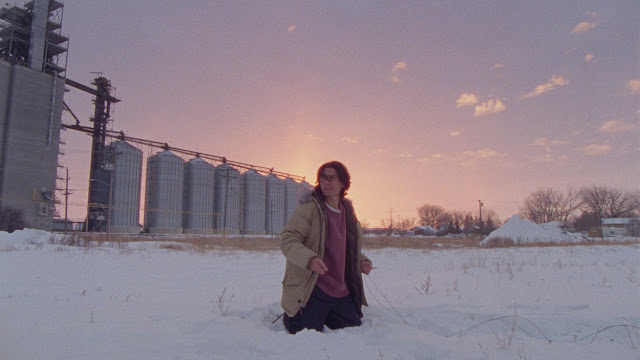 a man kneeling in the snow