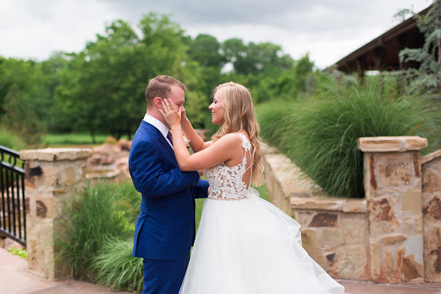 Something old, something new, something borrowed, something blue.  Sarah looked like she could have stepped right out of a Vogue Bridal magazine as she floated down the stairs in her beautiful wedding gown: a fitted, sleeveless, delicate lace bodice above a floor-length skirt, comprised of yards and yards of whimsical, white organza.  Tanner looked dapper in his royal blue suit, paisley tie, white rose boutonniere, and fancy, wood-grained leather shoes.  The bridesmaids and maid-of-honor wore individually designed, pale-pink, floor-length gowns and carried small bouquets similar to the bride’s pastel bouquet of beautiful, blush and ivory roses and ranunculus.      The SpringsEvent Venue in Edmond, OK, with its rustic and elegant accommodations, was the perfect setting For Sarah and Tanner’s intimate wedding and reception.  The morning began with First Looks for both the bride’s father, and then Tanner.  The clouds threatened rain throughout the morning—and almost drenched the bride and her maids during the picture-taking for the wedding party—but miraculously cleared up for the outdoor wedding nuptials.  The wedding couple were blessed to have so many people who traveled from throughout the country to celebrate their special day.   Sarah and Tanner agreed that their two favorite parts of the day were “getting to see each other during the first look, and then the actual wedding when we said our vows.”  Sarah said that during the first look, “we were able to spend those precious moments focusing on each other without all the hustle and bustle around us.”  After months of preparation and planning, she said, “the vows were also our favorite because we were finally getting married!”  Sarah’s suggestions to future brides, now that she has experienced her own wedding:  "Each and every moment is special:  getting ready, the first looks, walking down the aisle, the vows, the cake cutting, the dancing…take a moment or two to just slow down and take it all in…you’ll be glad you did!"  It was my pleasure to capture these beautiful memories for Sarah, Tanner and their families that will last forever.  For more information about my Wedding Packages, please visit my Weddings page on my website, www.michellevalantinephotography.com. 