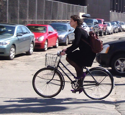 girl on a three speed with purple suede heels