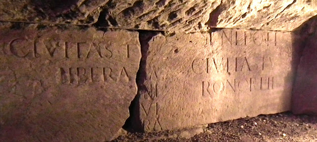 Reused stone with a Roman inscription in the foundations of the Tours city wall.  Indre et Loire, France. Photographed by Susan Walter. Tour the Loire Valley with a classic car and a private guide.