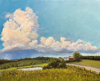 An acrylic painting by Deanna Skokan of a bright blue sky over green fields, trees, and farms, with a large storm cloud and rain off in the distance.