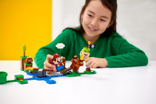 Girl is playing with LEGO Super Mario Toys