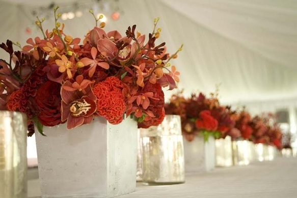 Gorgeous table centerpieces with red flowers including red orchids