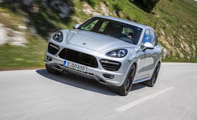 Silver 2013 Porsche Cayenne GTS driving down a mountain road