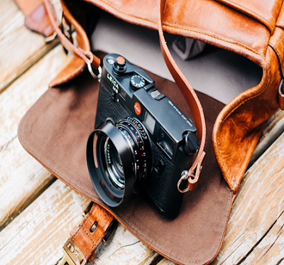 A Brown Leather Camera Bag with Camera