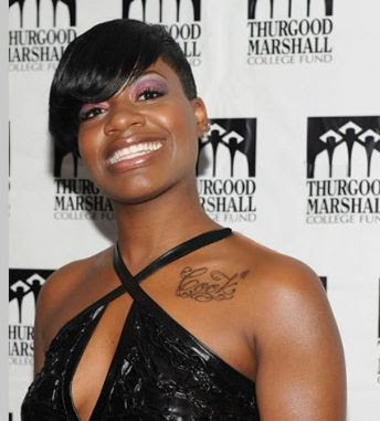  Fantasia with a musical note on her right ankle among other tattoos