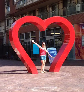 Girl posing inside the big red heart sculpture in the Distillery District, Toronto
