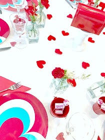 Felt hearts scattered over table.